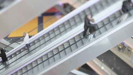 people in motion in escalators at the modern shopping mall. tilt shift lens shooting with super shallow depth of field.