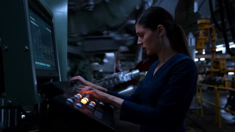 woman working at a control panel in a factory
