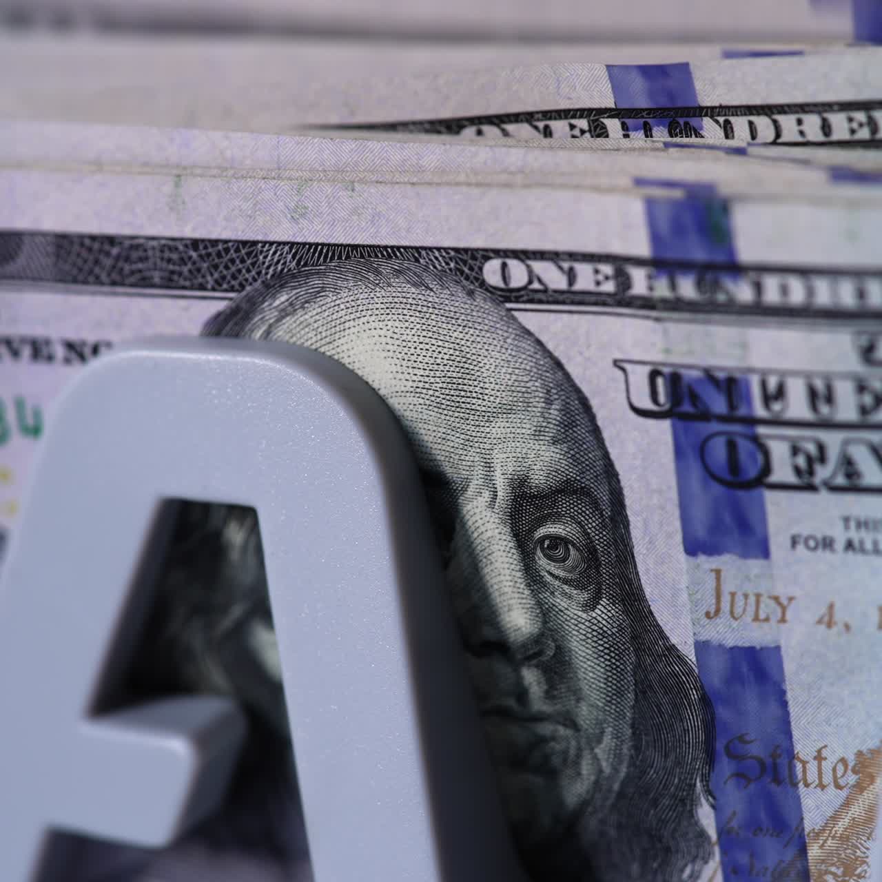 Benjamin Franklin portrait on the dollar bills. Cash counting machine counts American currency bills. Close up