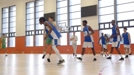 playing basketball in gym, athletes practicing drills and exercises on court