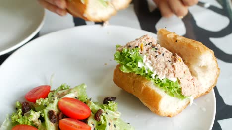 Tuna-sandwich-with-mayonnaise-on-a-plate-on-table