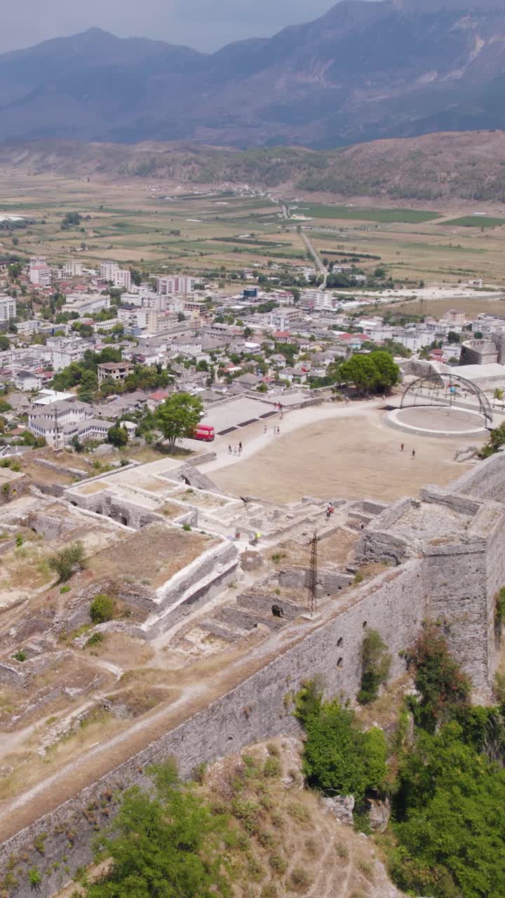 Hilltop fortress overlooking valley and town in Gjirokastër Albania vertical