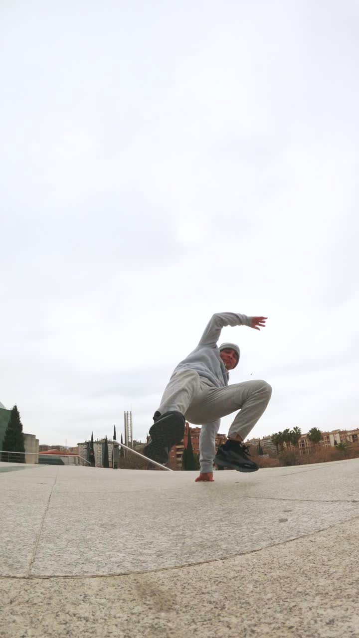 Breakdancer performing acrobatics in urban environment