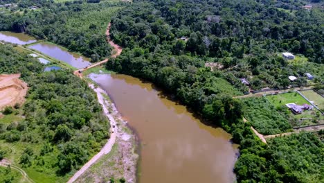 drone view of water holding ponds next to rainforest and farm in amazon region