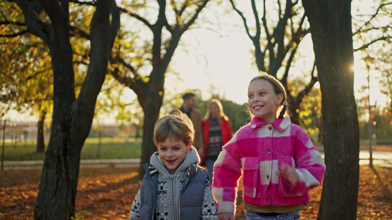 Family Walking in the Park on a Sunny Autumn Day