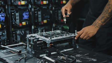 close-up of hands assembling a complex electronic device
