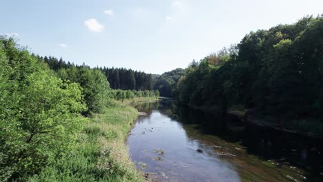 aerial drone shot of river in ardennes, north france