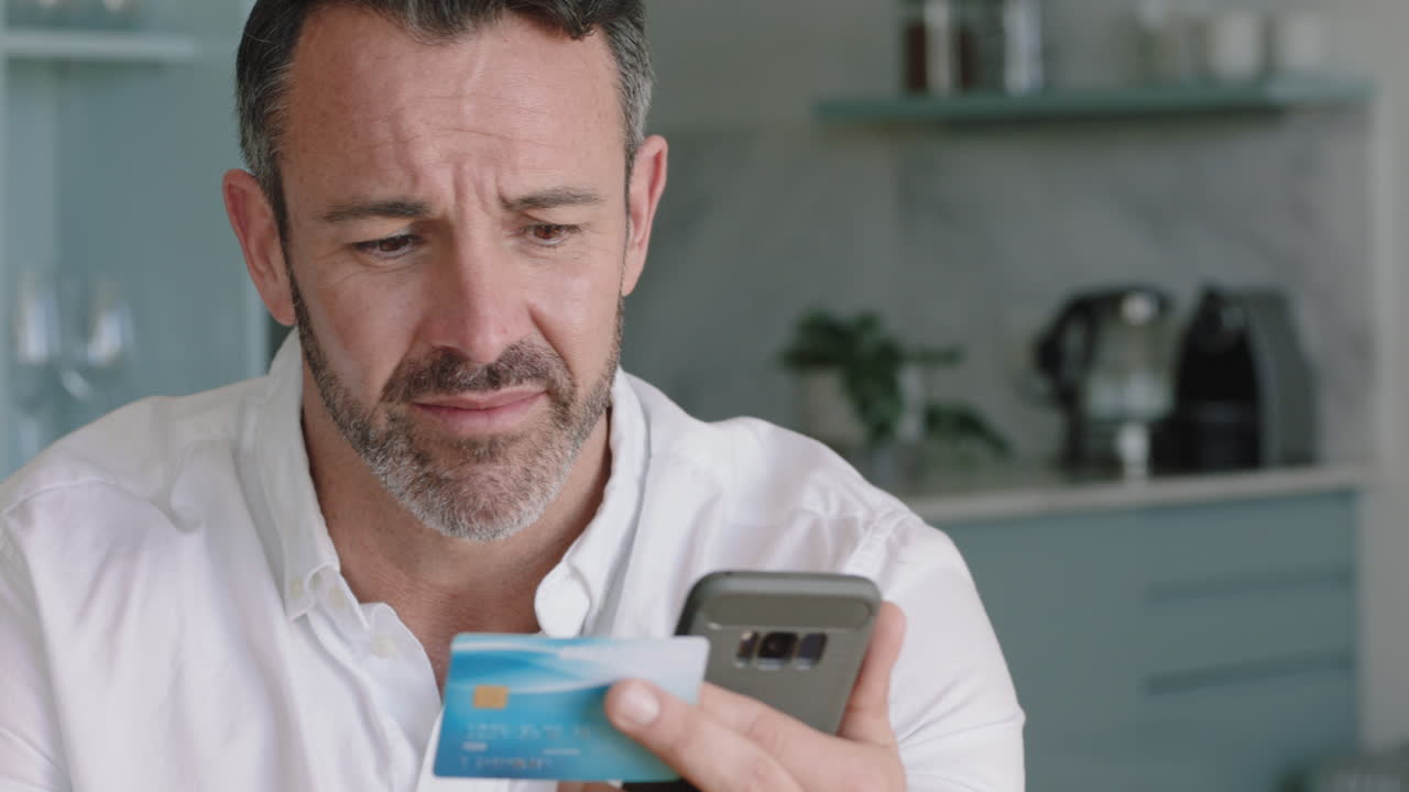attractive man using smartphone shopping online spending money on credit card mobile banking app with digital currency enjoying financial freedom