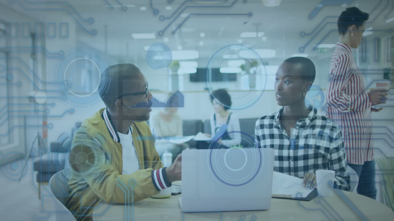 Animation of data processing over african american male and female colleagues discussing at office