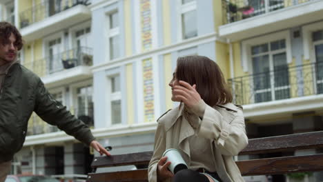 Happy-couple-having-date-on-bench-outdoor.-Man-hugging-woman-on-city-street.