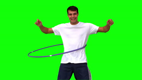 Man-playing-with-a-hula-hoop-on-green-screen