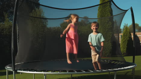 children jumping on a trampoline in a sunny backyard