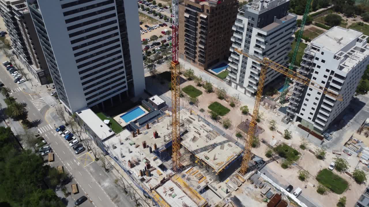 vista de arriba hacia abajo de un sitio de construcción entre grandes edificios de apartamentos