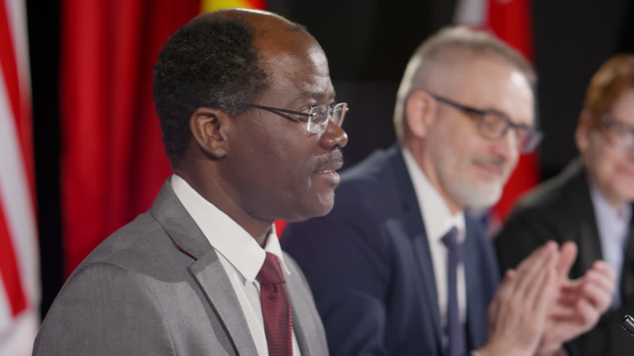 African American Diplomat Making Announcement at Press Conference