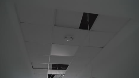 recently built premises with unfinished inside works. light system in the process of installation. wires hanging from the ceiling.