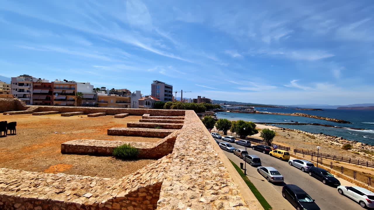 Coastal City View with Ruins and Parked Cars