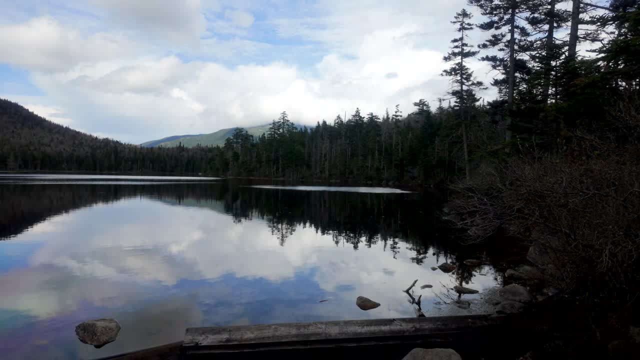 Low angle view of Desolation Lake and tree line, mountain reflection visible