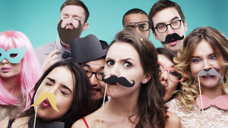 Multi-racial-group-of-funny-people-celebrating-slow-motion-party-photo-booth