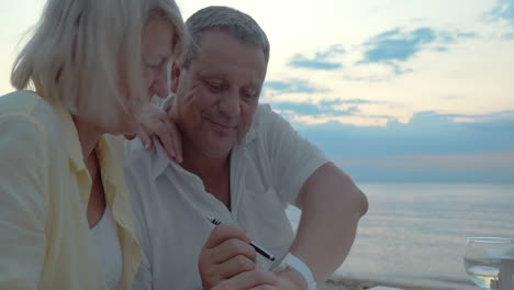 man and woman using smart watch outdoor