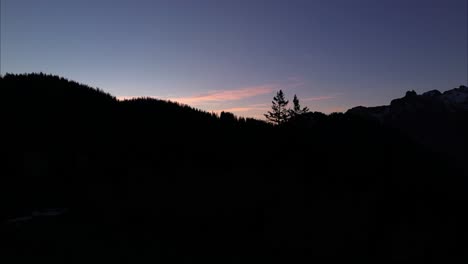 drone fly next to well with fresh spring water towards the sunrise behind the mountain