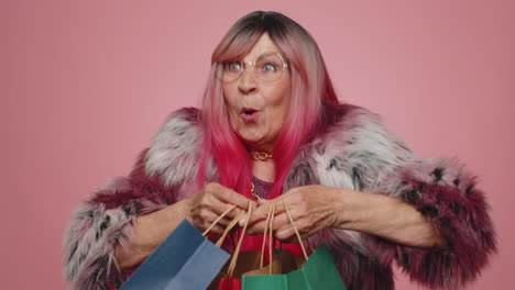 happy tourist woman showing shopping bags, advertising holidays discounts, amazed with low prices