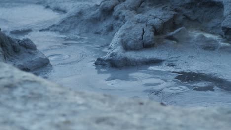 mud pit boiling in slow motion iceland. close up