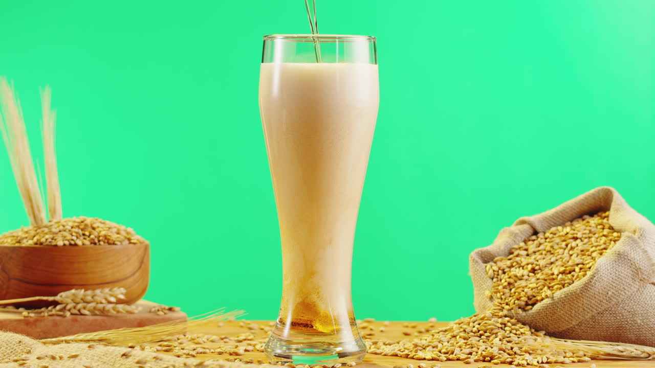 Pouring Beer into a Glass with Wheat Grains