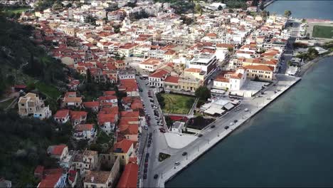 An-aerial-of-the-Gythio-town-in-Greece-with-small-houses-and-buildings-and-mountains-in-the-background