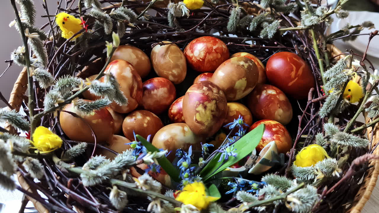 Colorful Easter eggs in a decorated nest, symbolizing festive tradition