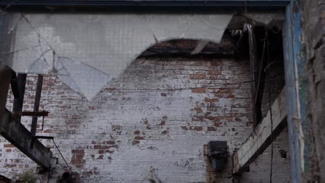 broken window in brick built abandoned factory panning shot