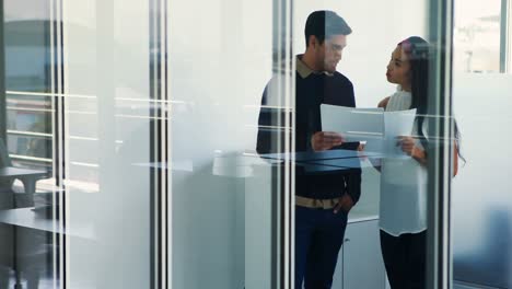 Male-and-female-executive-discussing-over-documents-4k