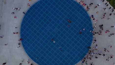 People-At-The-Greeting-To-The-Sun-Monument-In-Zadar,-Croatia-At-Dusk