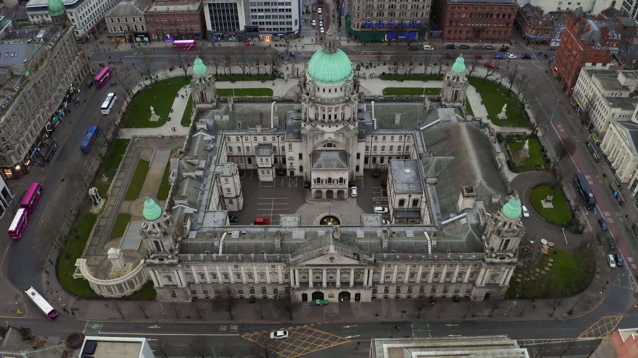 Static aerial shot capturing Belfast Town Hall surrounded by moving traffic, ideal for an establishing shot
