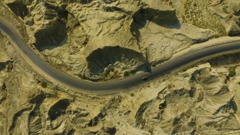 aerial perspective showing a winding road on the buzzi top makran coastal highway, surrounded by rugged, dramatic landscapes