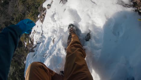 a man struggling to descend the mountain