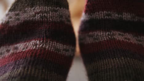 Füße-Mit-Warmen-Wollsocken-An,-Gestreifte-Stricksocken,-Nahaufnahme