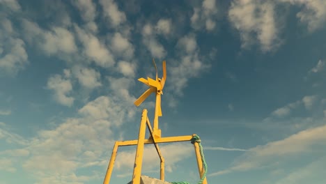 A-proud-yellow-navigation-buoy-stands-tall-on-the-dock-of-a-coastal-Spanish-fishing-village,-representing-maritime-safety-and-guidance-amidst-the-bustling-port-activities