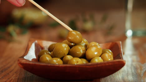 green olives in wooden bowl