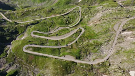 Early morning light reveals serpentine road of Nufenen Pass high in Swiss Alps