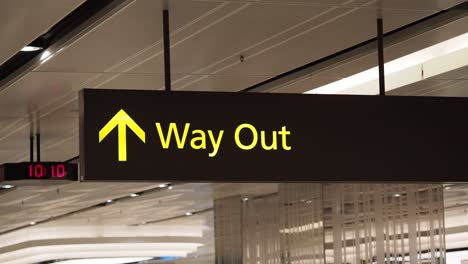 way out sign with up arrow and digital clock