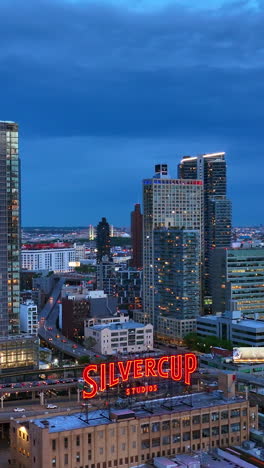 well-known film silvercup studios in new york. fantastic city architecture with evening lights. blue sky background. vertical video