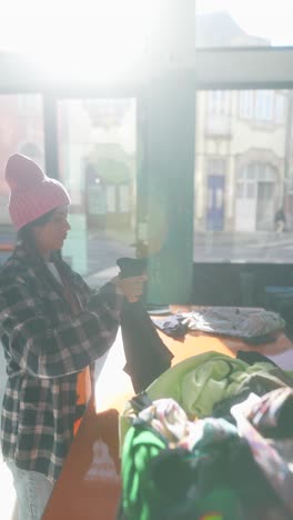 woman sorting donated clothing