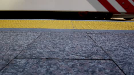 a light-rail train stops at a station and the train door slides open