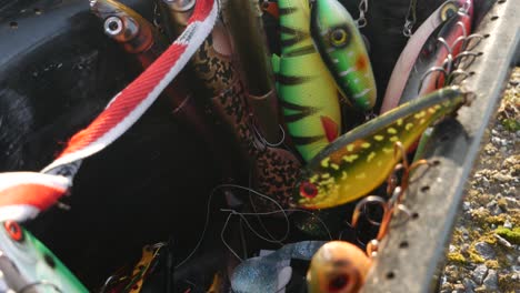 Close-up-pan-shot-of-fishermans-fishing-lure-in-basket-on-a-sunny-day