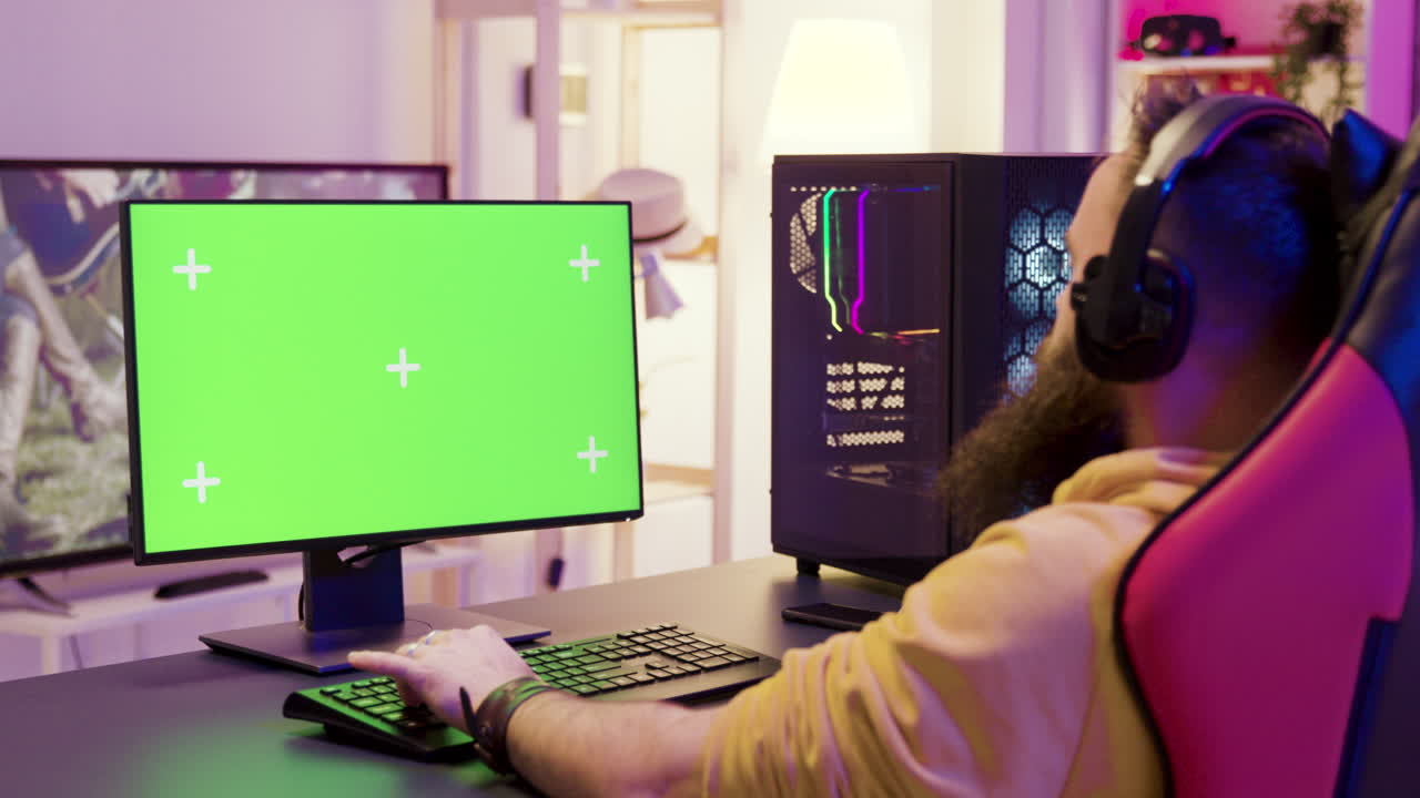 Man Gaming on Computer with Green Screen