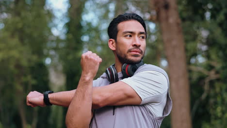 Asian-man-stretching-body-in-forest-before