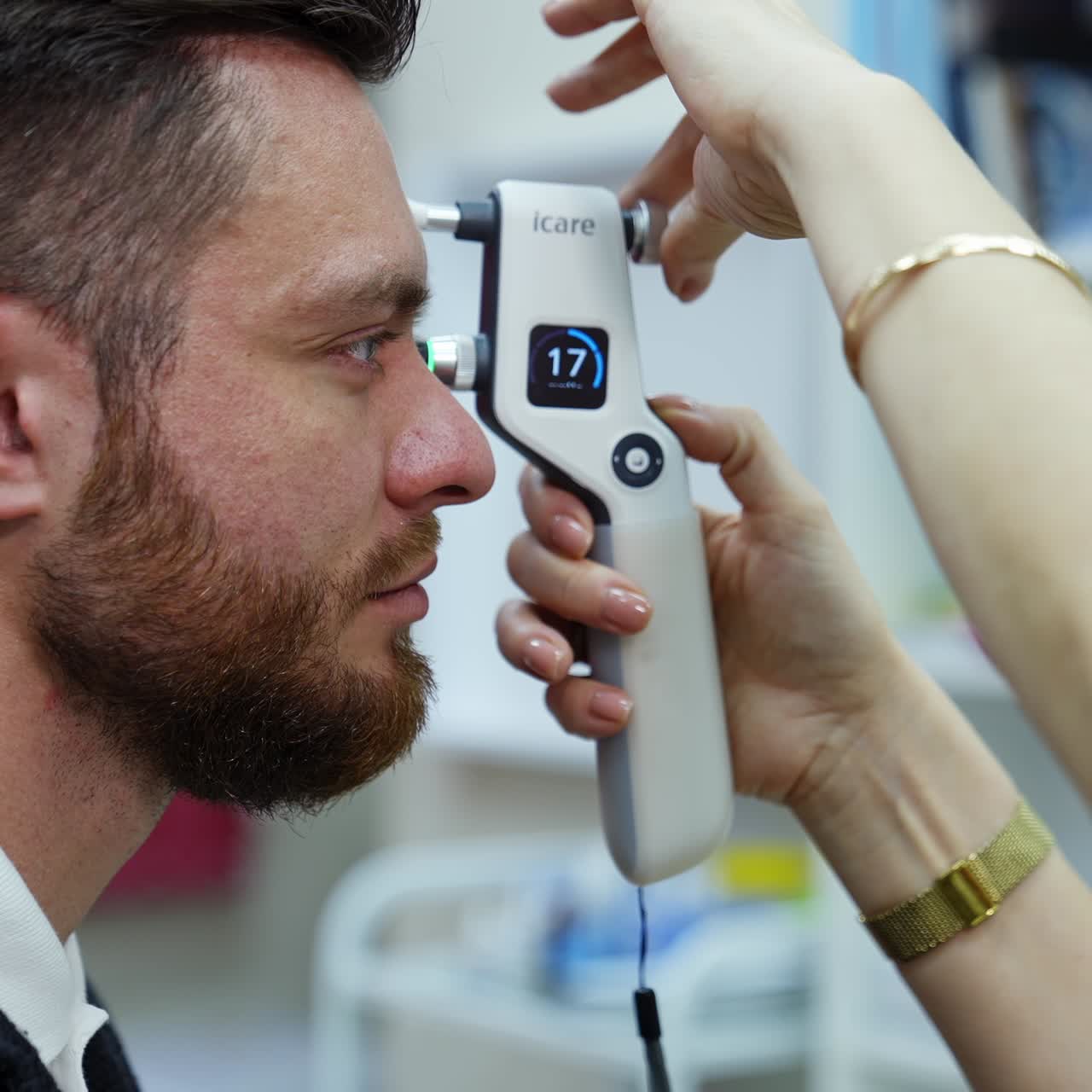 Doctor checking eyes with device