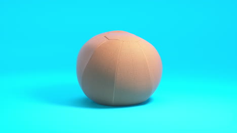 Animación-Deportiva-En-3D:-Balón-Medicinal-Fotorrealista-Gira-Sobre-Un-Fondo-Azul-Limpio