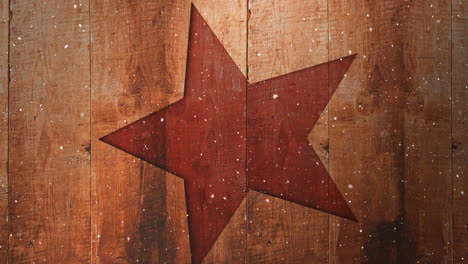 video composition with snow over christmas ornaments on wood