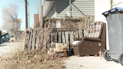 discarded chair boxes and containers in an alley